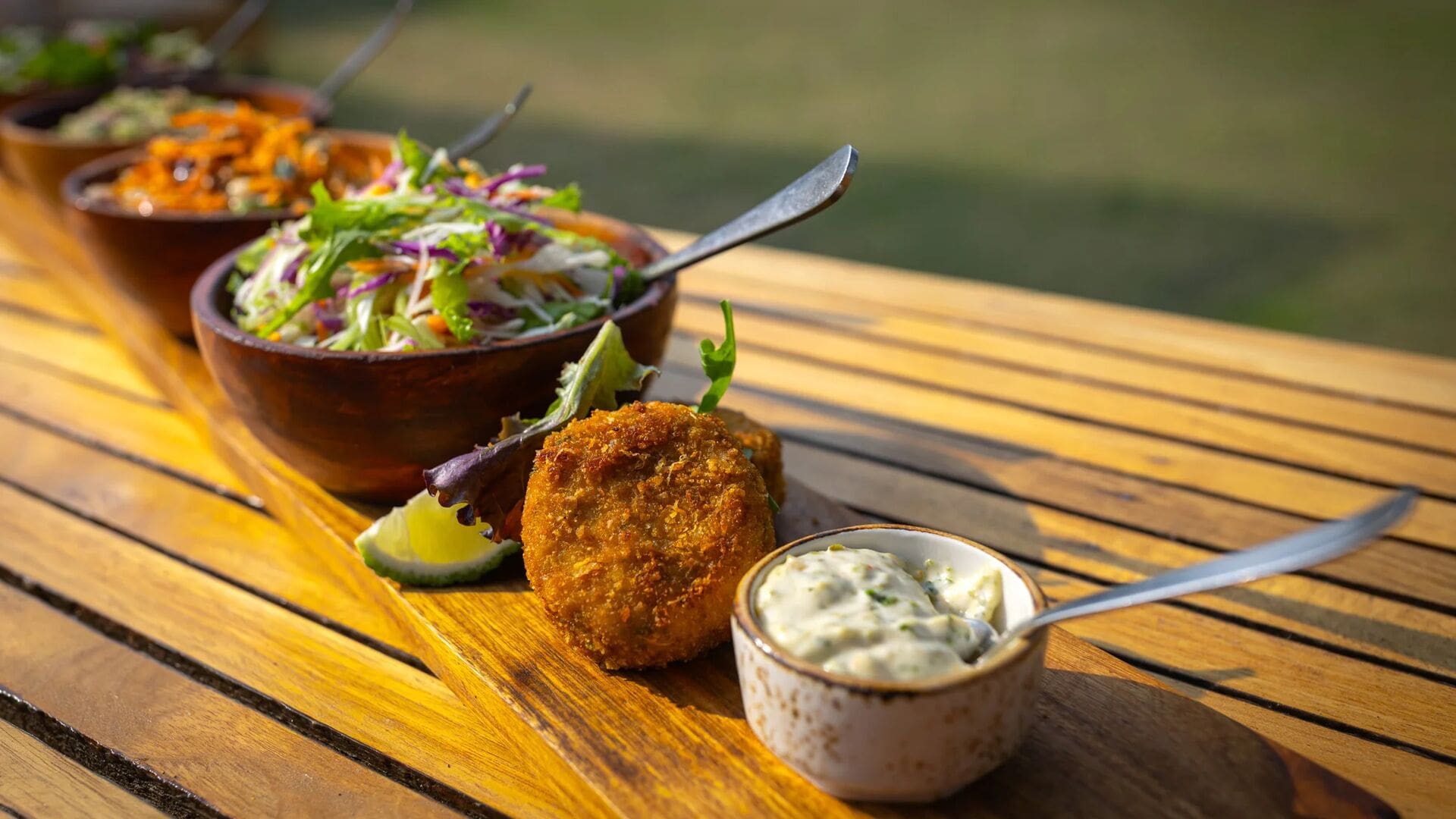A chef preparing a plated meal in the kitchen of a luxury safari camp in Kenya